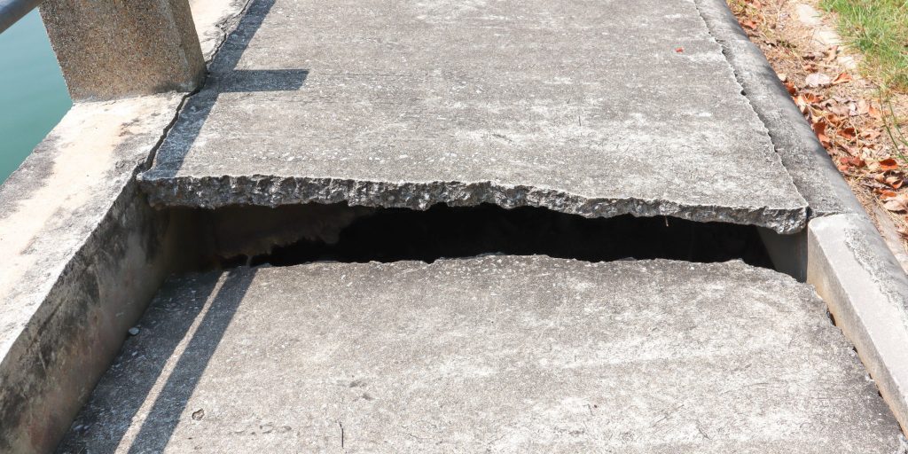 Concrete road with cracks With the shadow of the sunlight